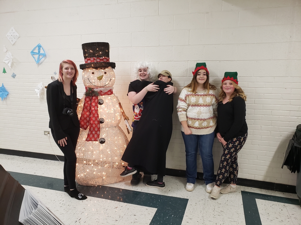 students posing with a snowman
